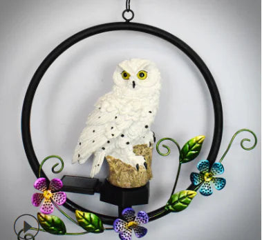 Decorative owl ornament with flowers on a gray background