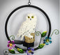 Decorative owl ornament with flowers on a gray background