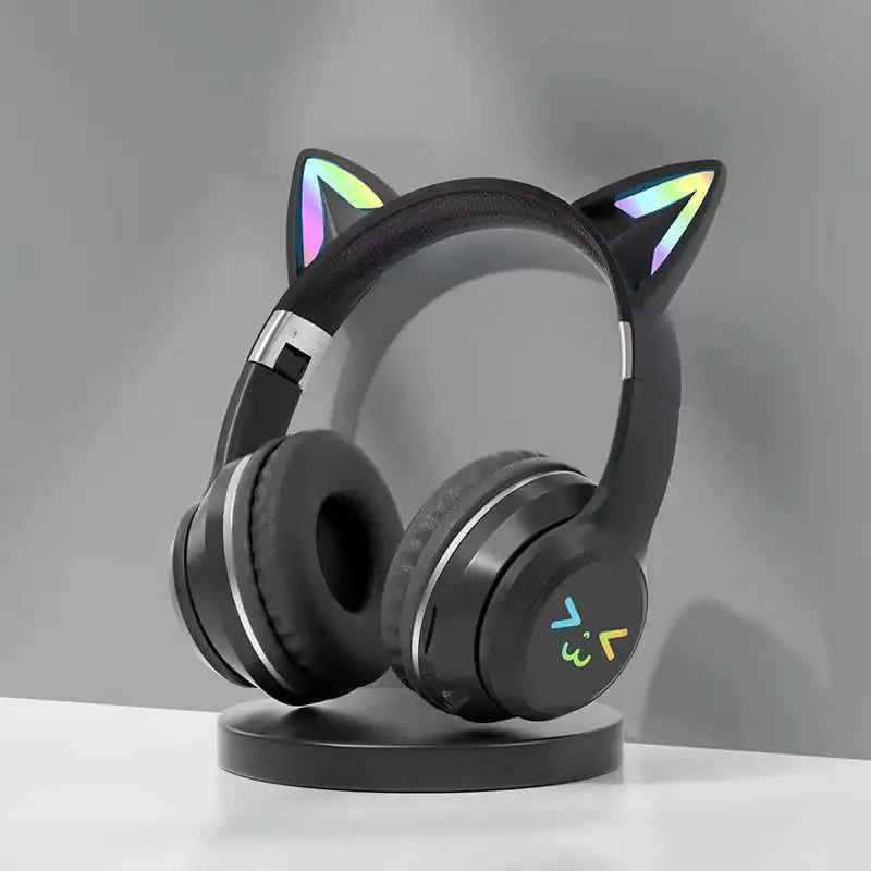 Black cat ear headphones on a stand with a gray background