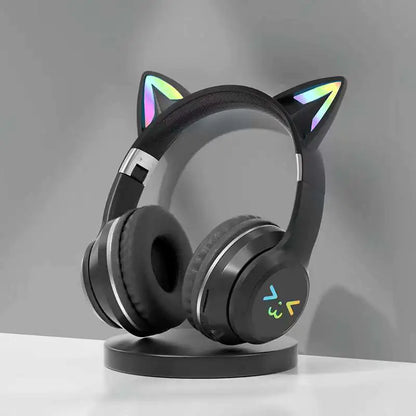 Black cat ear headphones on a stand with a gray background
