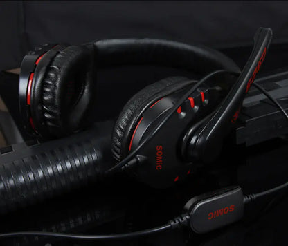Black headphones with red accents on a dark background