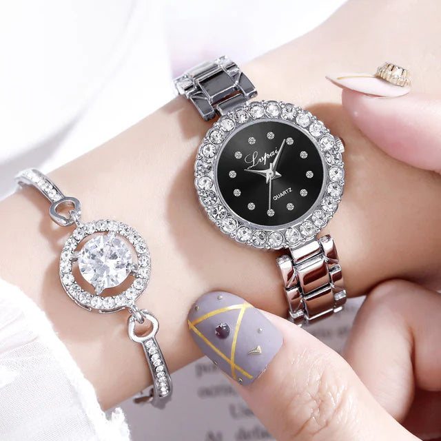 Silver watch with black dial on a wrist, close-up view
