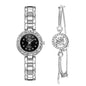 Silver watch and earrings set on a white background