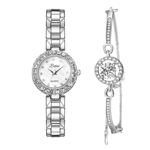 Silver watch and earrings set on a white background