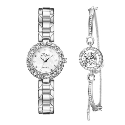 Silver watch and earrings set on a white background