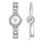 Silver watch and earrings set on a white background